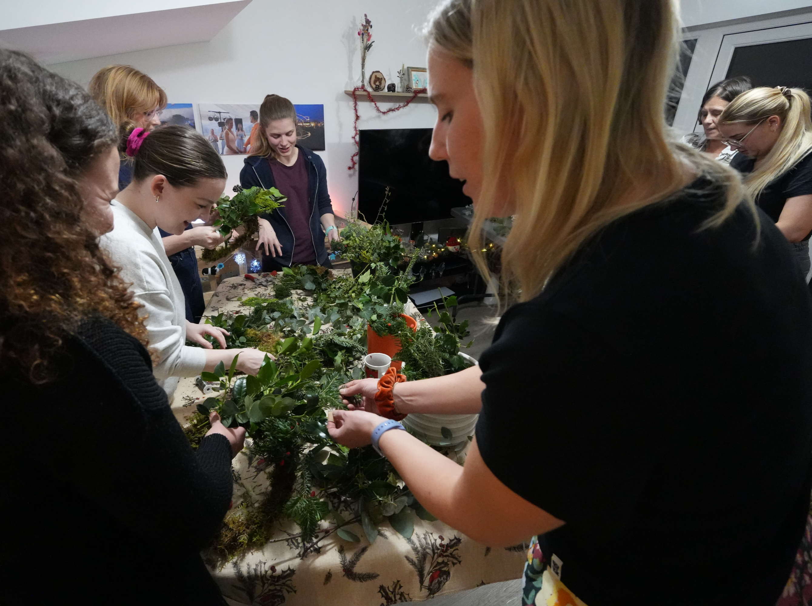 Philippa helping a participant at a Christmas floral workshop
