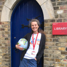 Climate Ed volunteer holding a globe