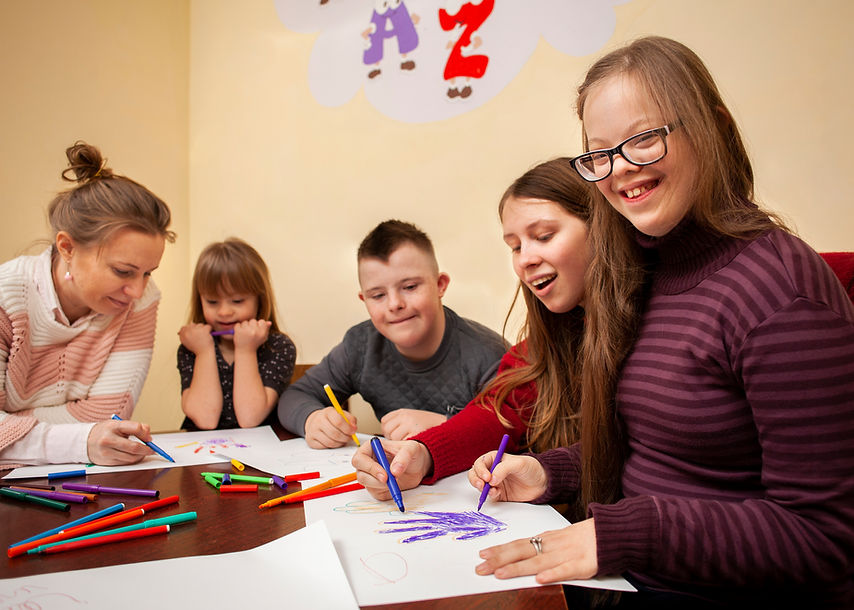 happy-girl-with-down-syndrome-posing-while-drawing.jpg