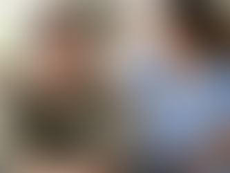 Middle-aged man wearing a MyQRMed medical ID bracelet while speaking with a nurse in a home care setting