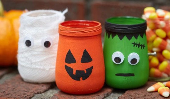 Glass bottles painted to look like orange pumpkin, green monsters and wrapped with gauze to look like mummy.