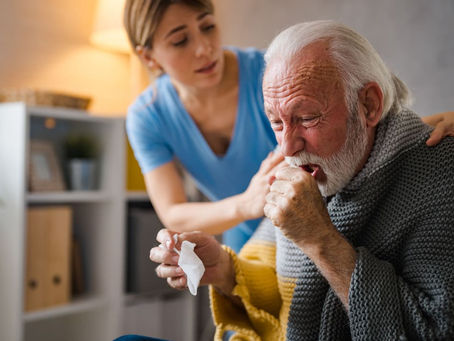 an old man coughing due to seasonal allergies