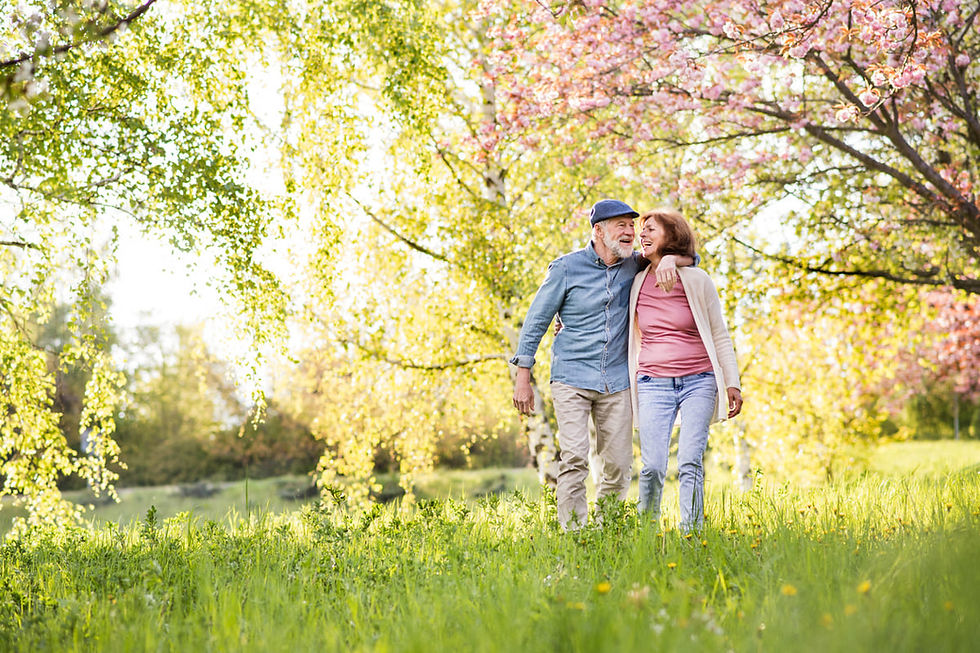 Two active seniors enjoy a spring walk outside while following spring safety tips for adults