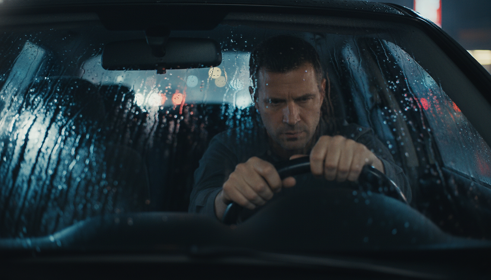 Man sitting alone in car showing emotional stress and internal pressure