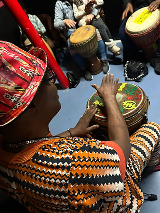 Person playing a drum in a group