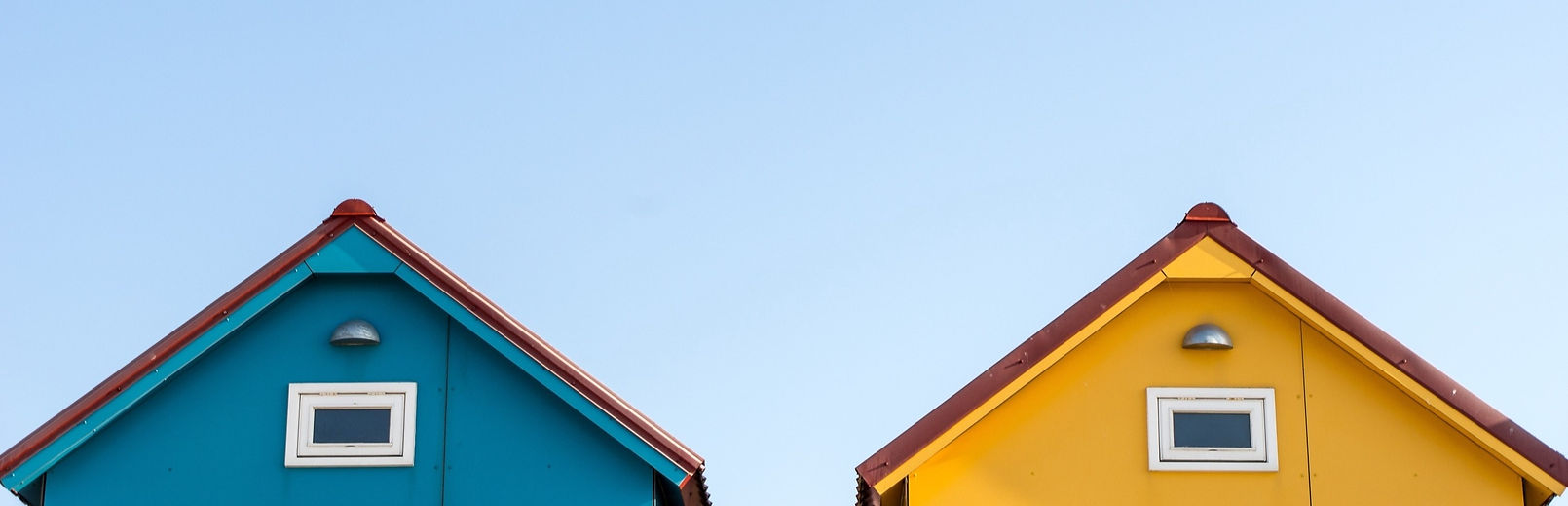 roofs-of-small-blue-and-yellow-houses-with-copyspace-in-the-sky_edited_edited_edited_edite