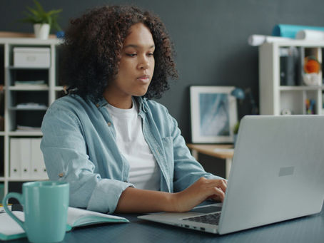 Woman working remotely as a virtual assistant from home office