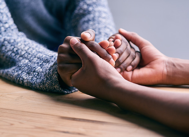 Two women holding hands