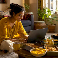 Person browsing Indian snacks online at home