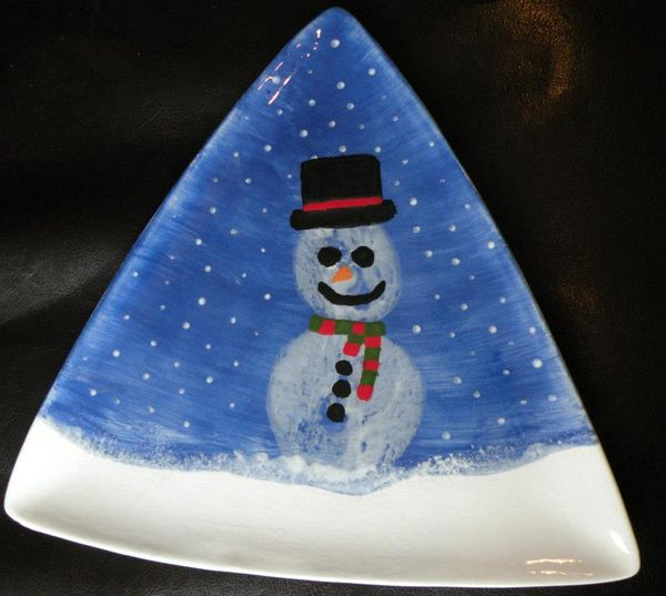 Boob prints on a triangle plate the prints have been turned into a snowman.