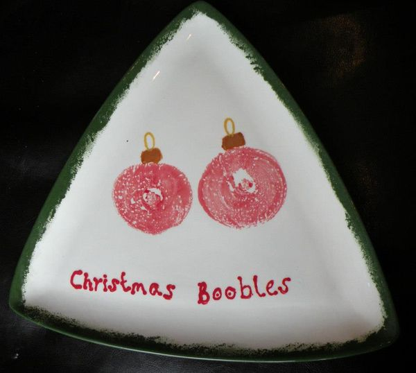 A triangle plate with boob prints that have been turned into baubles, there is the wording 'christmas boobles' beneath the prints.