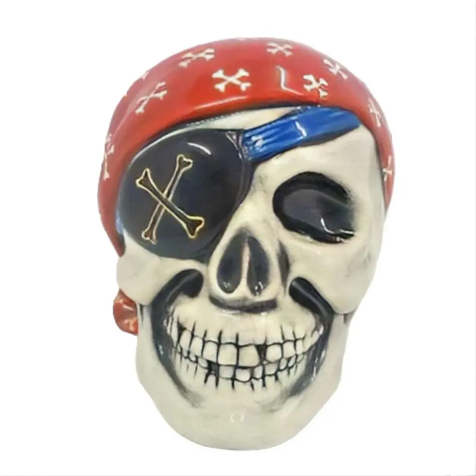 Painted pirate skull money bank with scarf and bandana