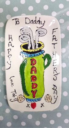 A rectangle plate decorated with a golf theme for fathers day