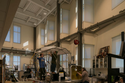 CU aerospace lab: students are building something in the middle of the picture, but the picture is intended to showcase light-filtering, motorized shades.