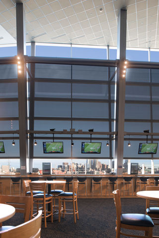 3rd Level club suites at Empower Stadium. extra tall windows with seating, TVs, and vending. this picture is intended to showcase the colossal window coverings. 