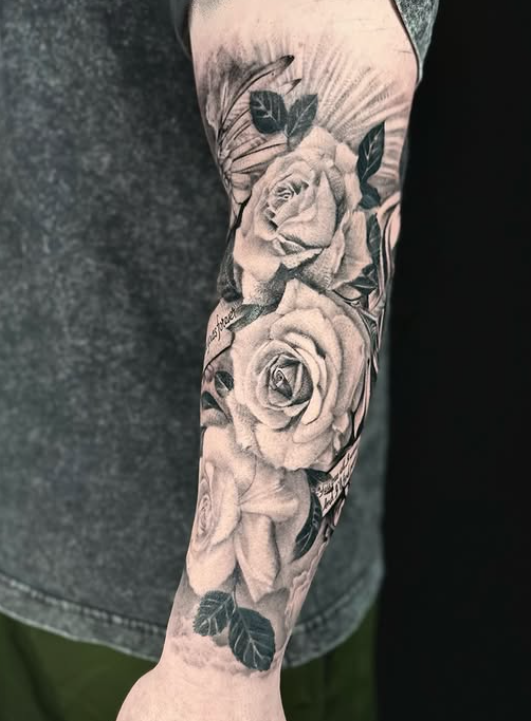 Realistic rose sleeve tattoo by Inkverse Tattoo Studio in Katy, TX