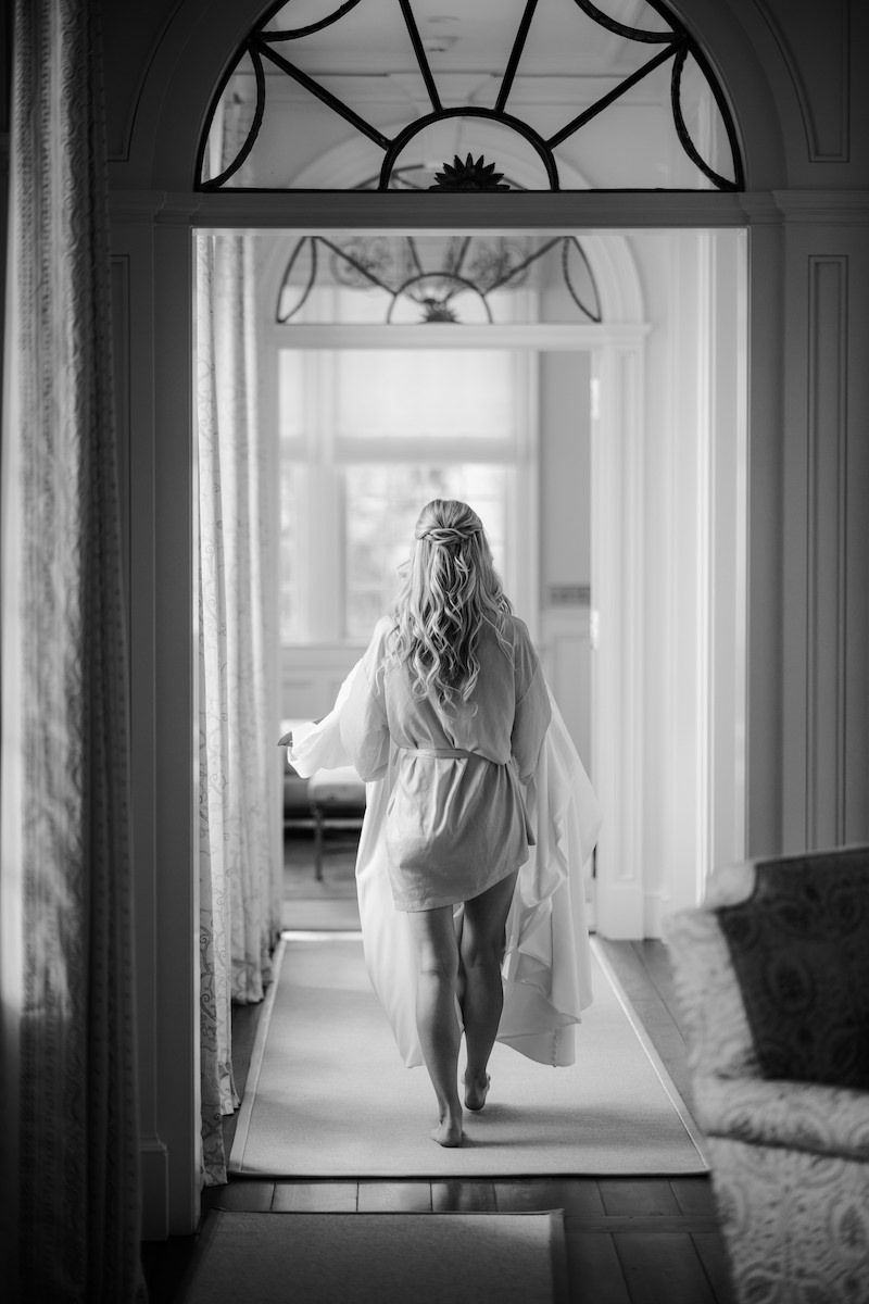 bride carrying her wedding dress to go put on on her wedding day
