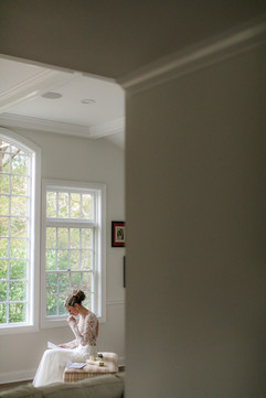 bride crying as she reads the card from her groom on her wedding day