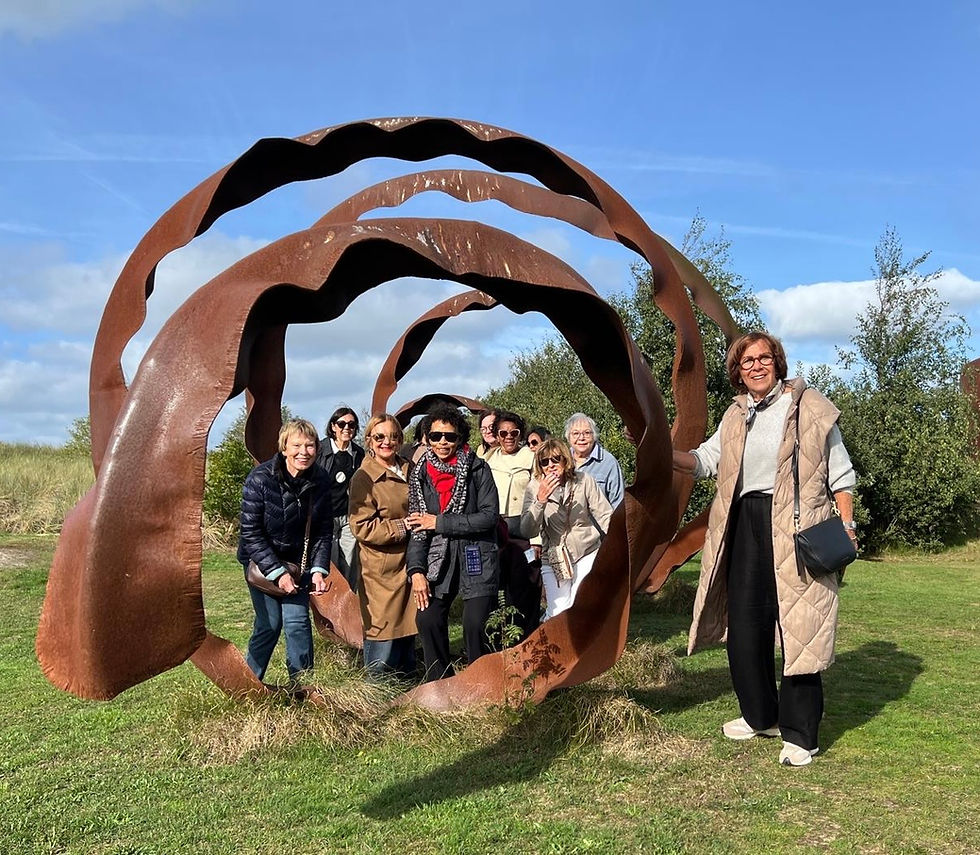 IWC Amsterdam members on a group outing in front of a large sculpture