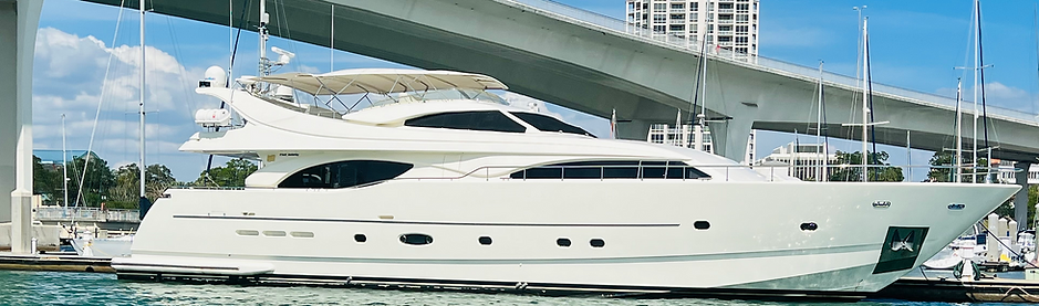 yacht-parked-in-blue-water-near-a-bridge-.png