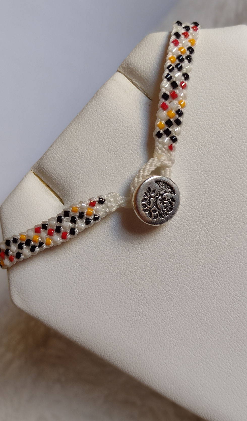 Hand braided Kumihimo bracelet of multi on white