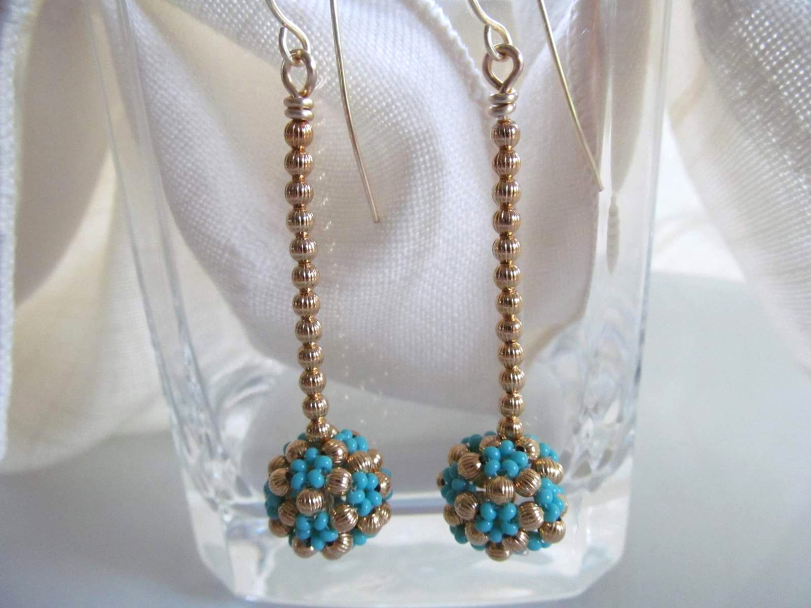 Handmade earrings of hand beaded blue glass and brass beads on gold ear wires