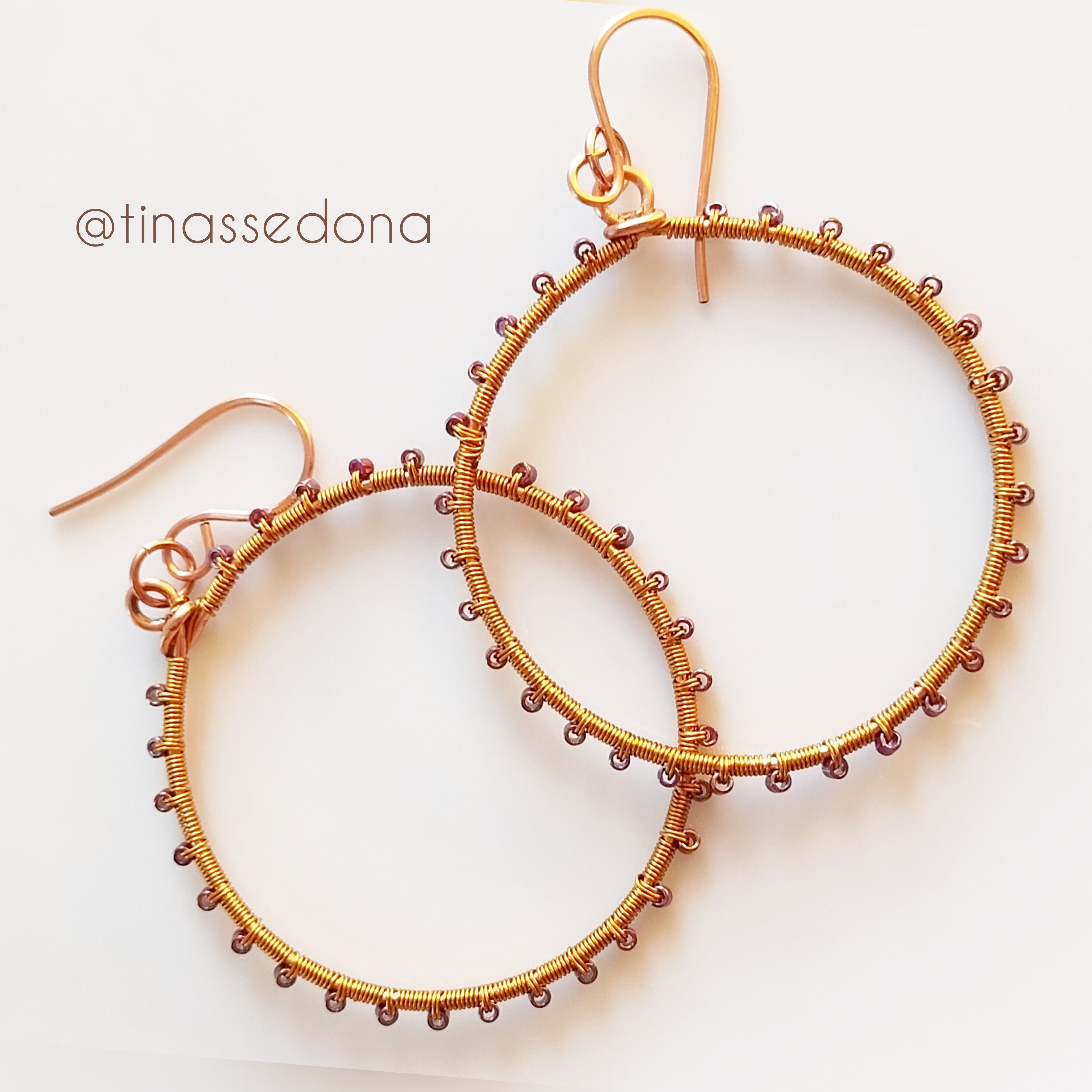 Hand woven purple glass on bronze hoop earrings