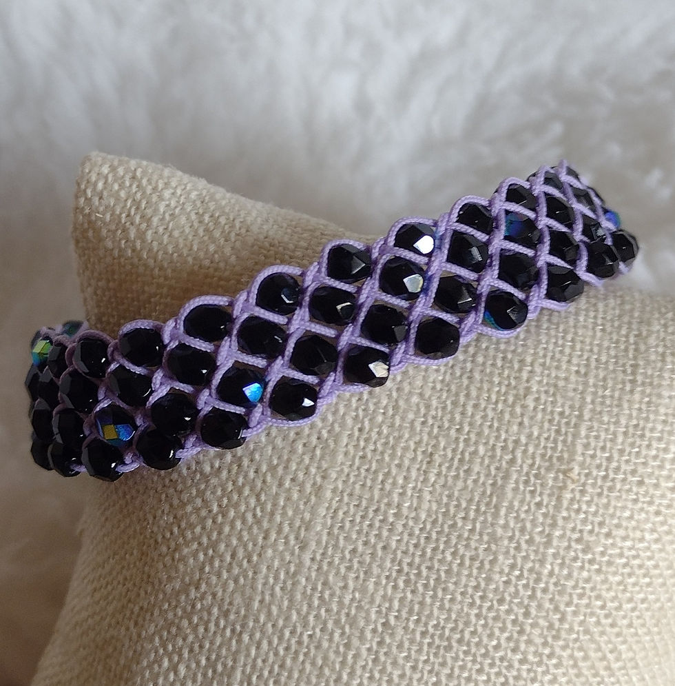 Hand woven bracelet of lavender and purple glass
