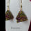 Thumbnail: Hand beaded purple and green earrings on gold