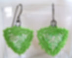 Handmade earrings of hand beaded matte spring green glass on titanium ear wires