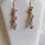Thumbnail: Handmade earrings of colored glass bead spiral on knitted silver