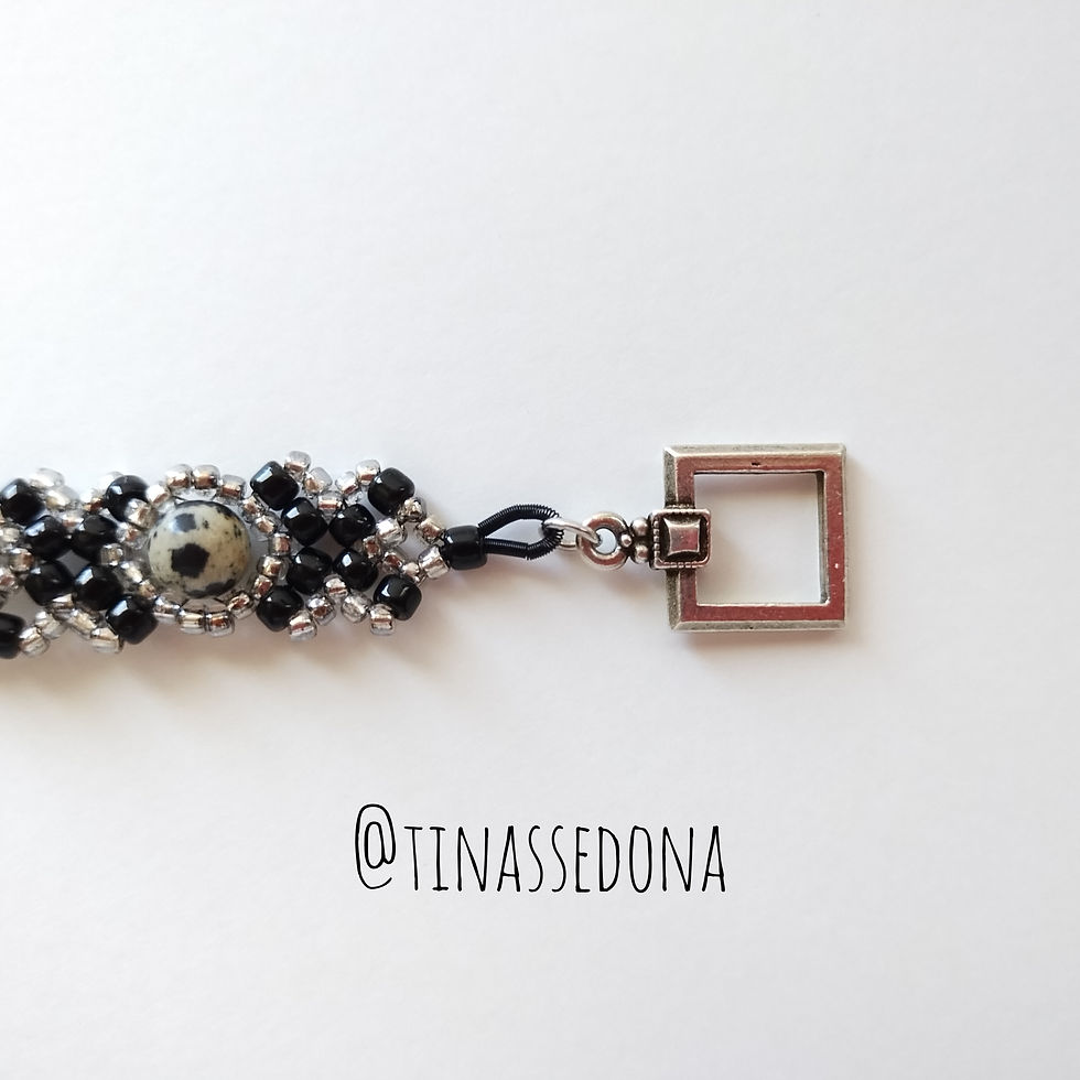 Hand woven bracelet of black and silver glass on dalmatian jasper 7 in