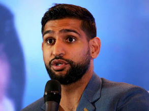 Amir Khan was escorted off an American Airlines flight which he believes was racially motivated