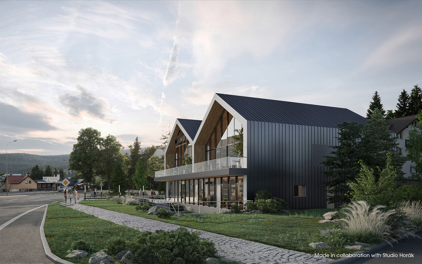 Modern gabled retail building with dark metal cladding and a glass balcony beside a road in a forested village.