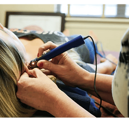 woman receiving ear accupuncture