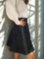 Embroidered black skater skirt with soft structure and high-waisted silhouette.