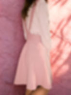 Pink corduroy pinafore dress with a flared skater skirt silhouette.