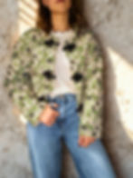 Green floral quilted jacket with lightweight padding and black toggle closures in a straight, relaxed fit.