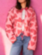 Pink heart print quilted jacket with satin tie-front bows and a cropped silhouette.