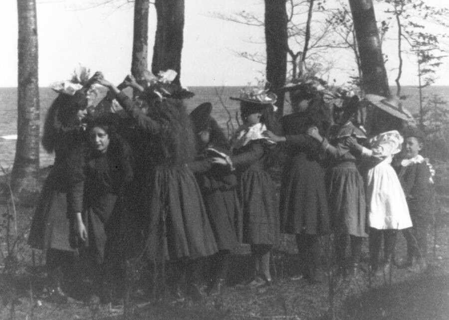 A group of school girls play the London Bridge game in 1898.
