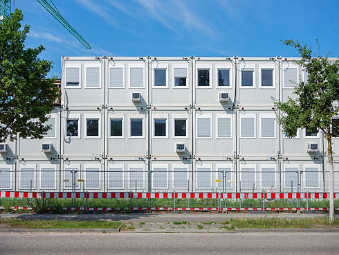 stacked arrangement of modular container buildings, likely used as temporary site offices 