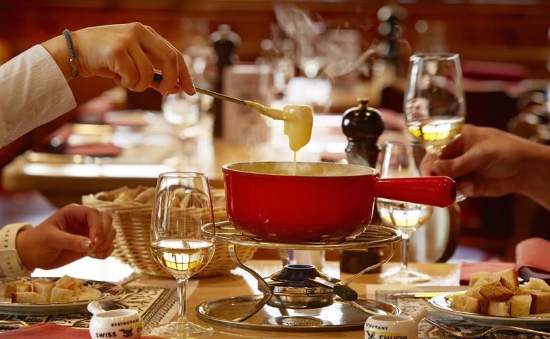 A dining moment at the Swiss Chuchi Restaurant in Zurich, Switzerland, known for its traditional atmosphere.