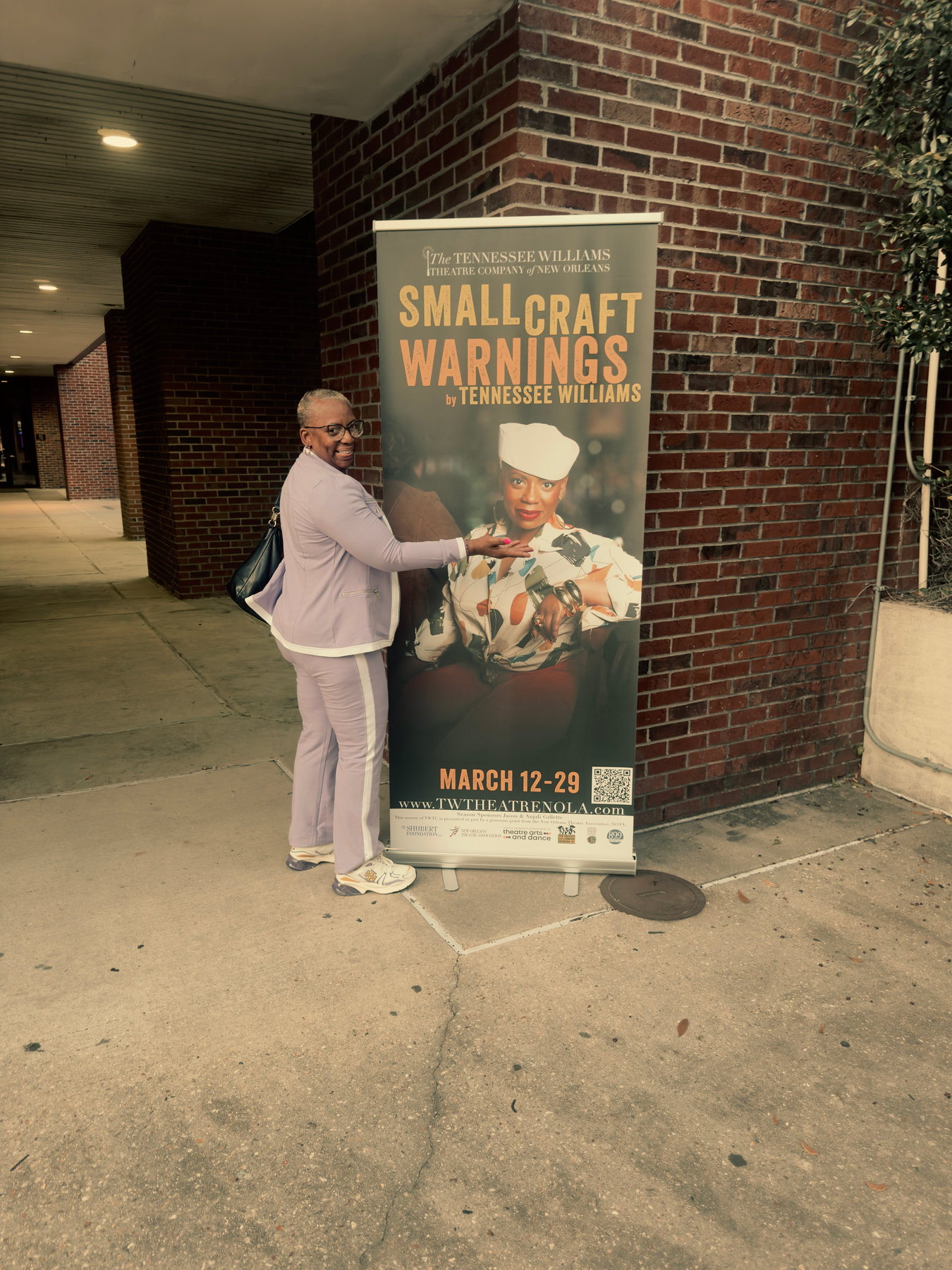 Small Craft Warnings banner featuring LaKesha Glover as Leona outside the theater