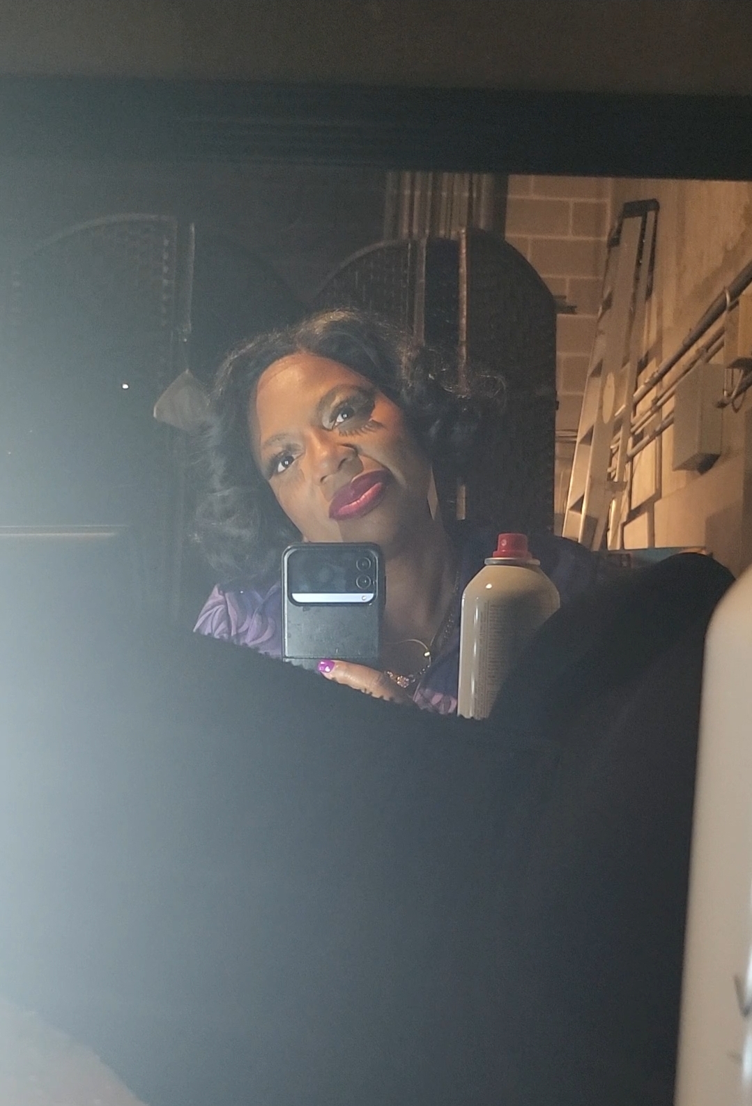LaKesha Glover in costume backstage, taking a mirror photo