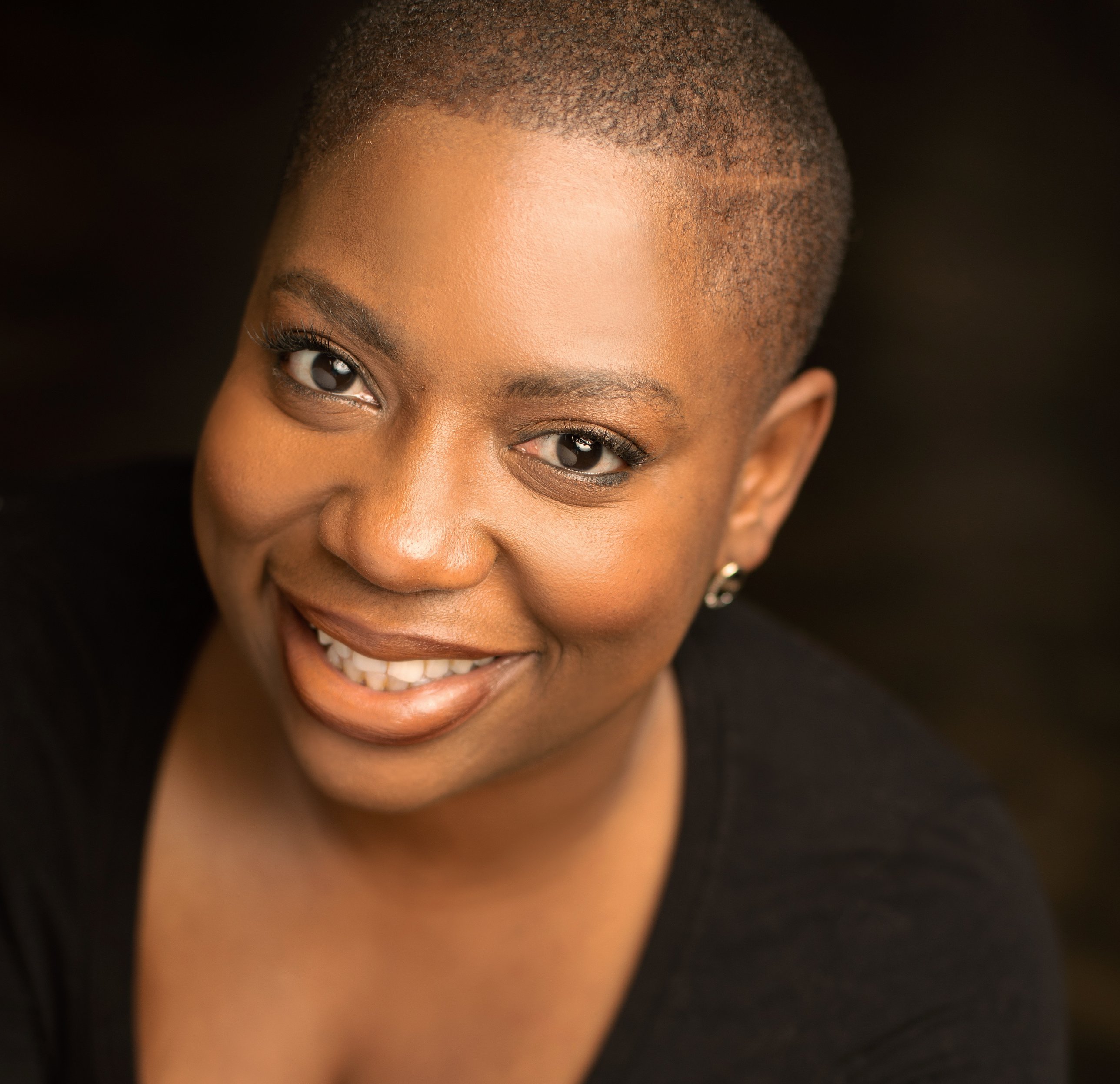Warm headshot of LaKesha Glover in black, smiling