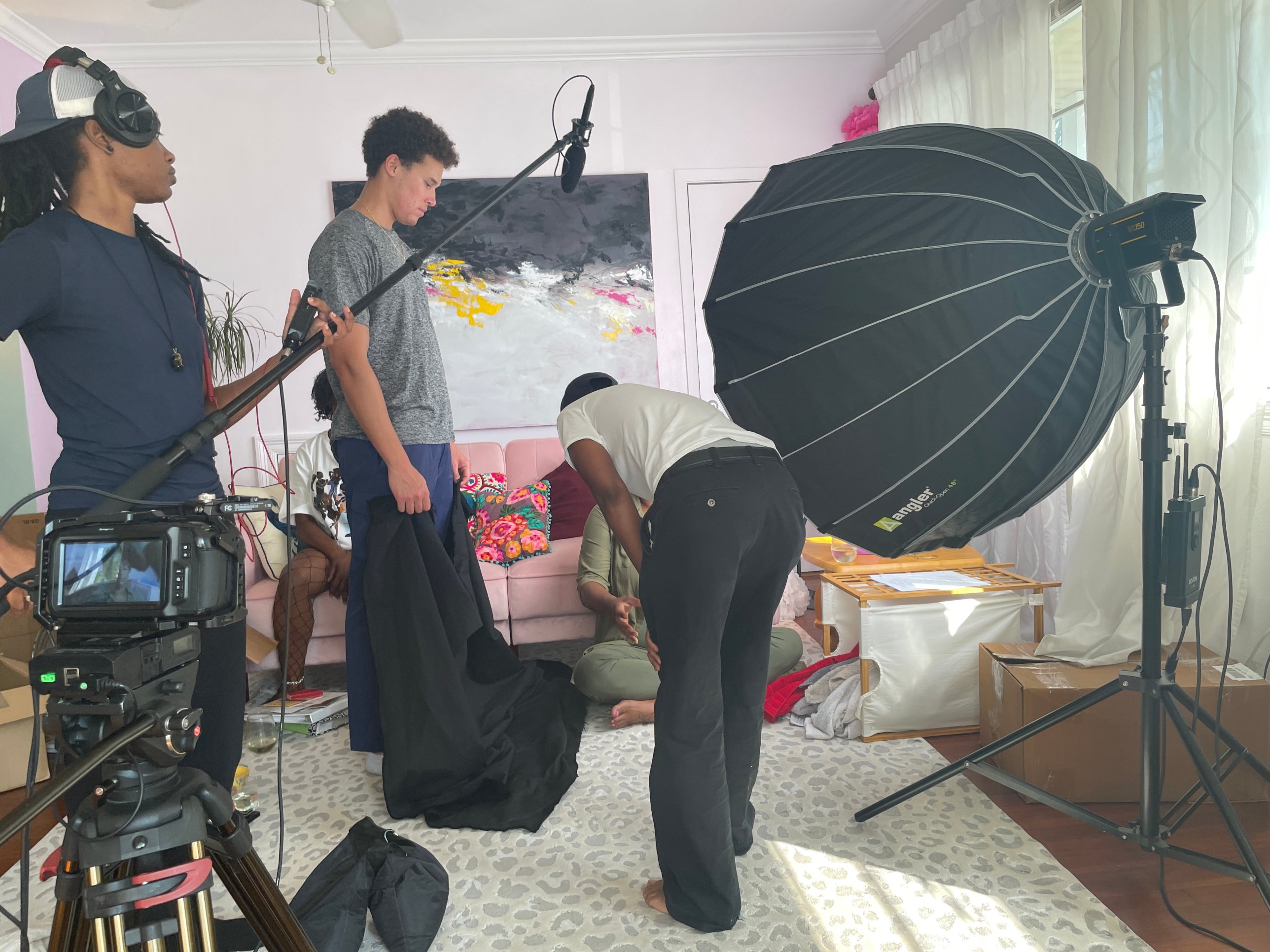 Film crew with camera, boom microphone and lighting setting up a scene on the set of Rosebud