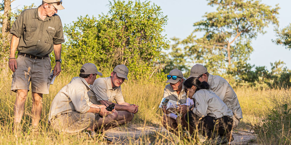 Bushwise students practice track and sign while their trainer observes