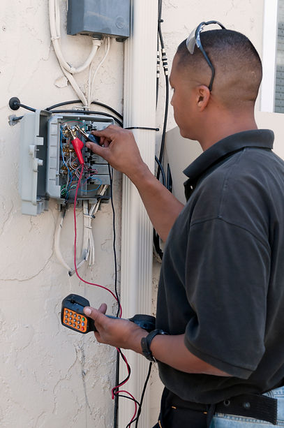 A professional providing rewiring services for properties in Pyrford.
