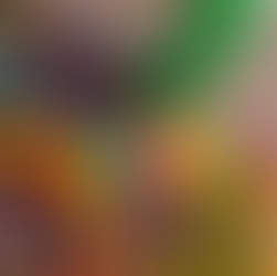 A sensory bin using a clear tub with colorful chickpeas, fidget toys, plastic tweezers, colorful blocks and alphabet letters