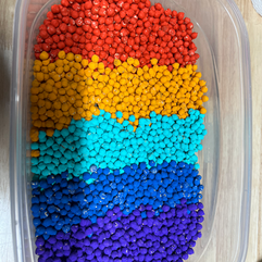 colorful painted chickpeas in a plastic container